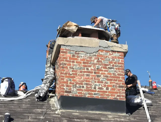 Pineville Chimney Sweep installing a custom chimney crown in Pineville, NC